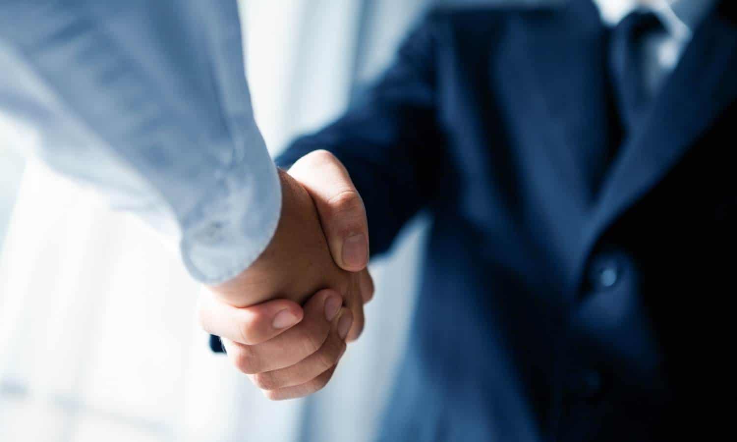 Bounce Back Digital employee handshake with client